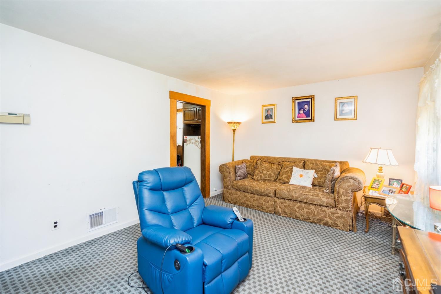 32 Idlewild Road Edison, NJ 08817 - Photo 5 of 14 a living room with furniture a couch and a window