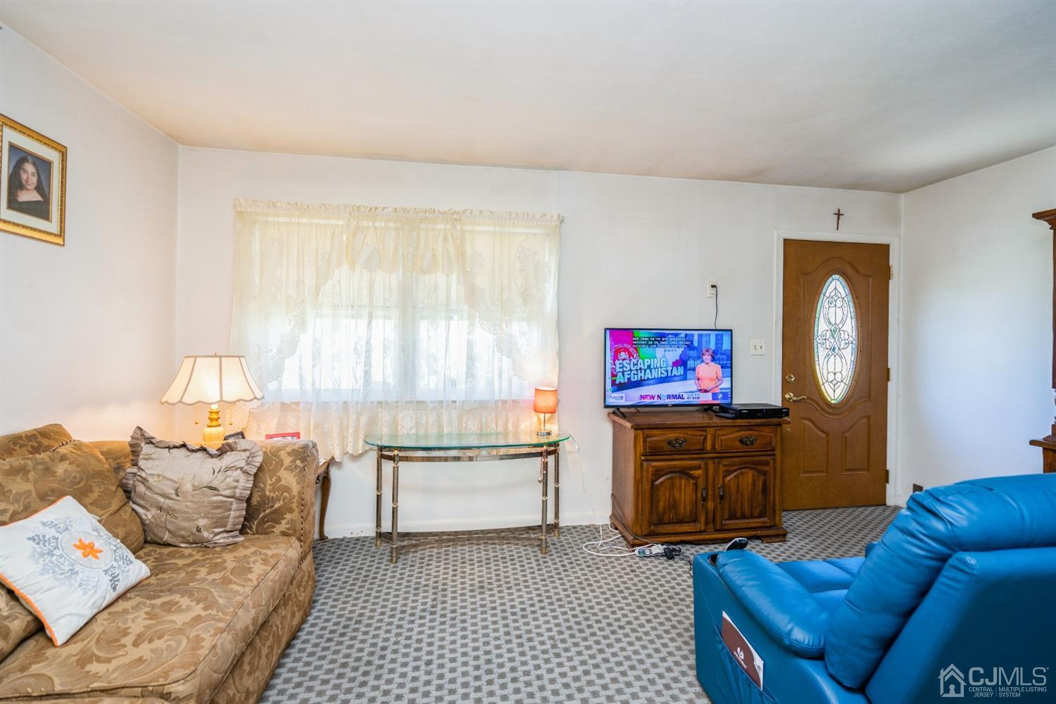 32 Idlewild Road Edison, NJ 08817 - Photo 6 of 14 a living room with furniture and a flat screen tv