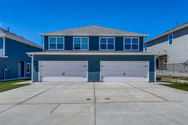 a front view of a house with a garage