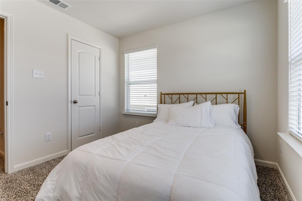 320 Stone Court Princeton, TX 75407 - Photo 8 of 15 a large bed with a night stand and a window