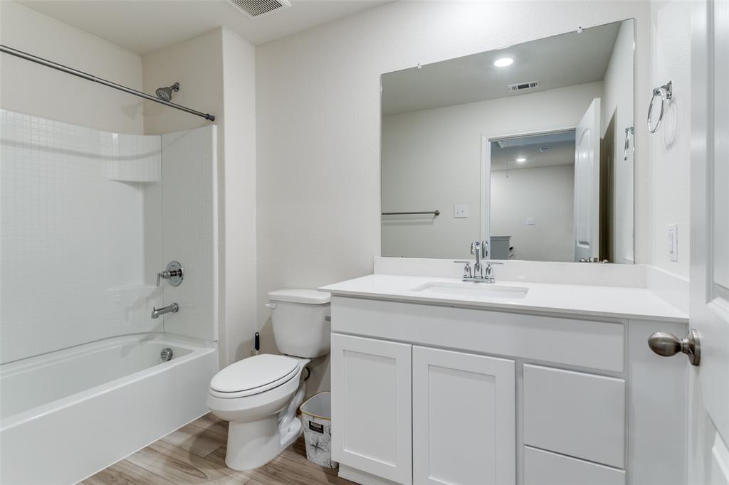 320 Stone Court Princeton, TX 75407 - Photo 9 of 15 a bathroom with a granite countertop sink toilet and shower
