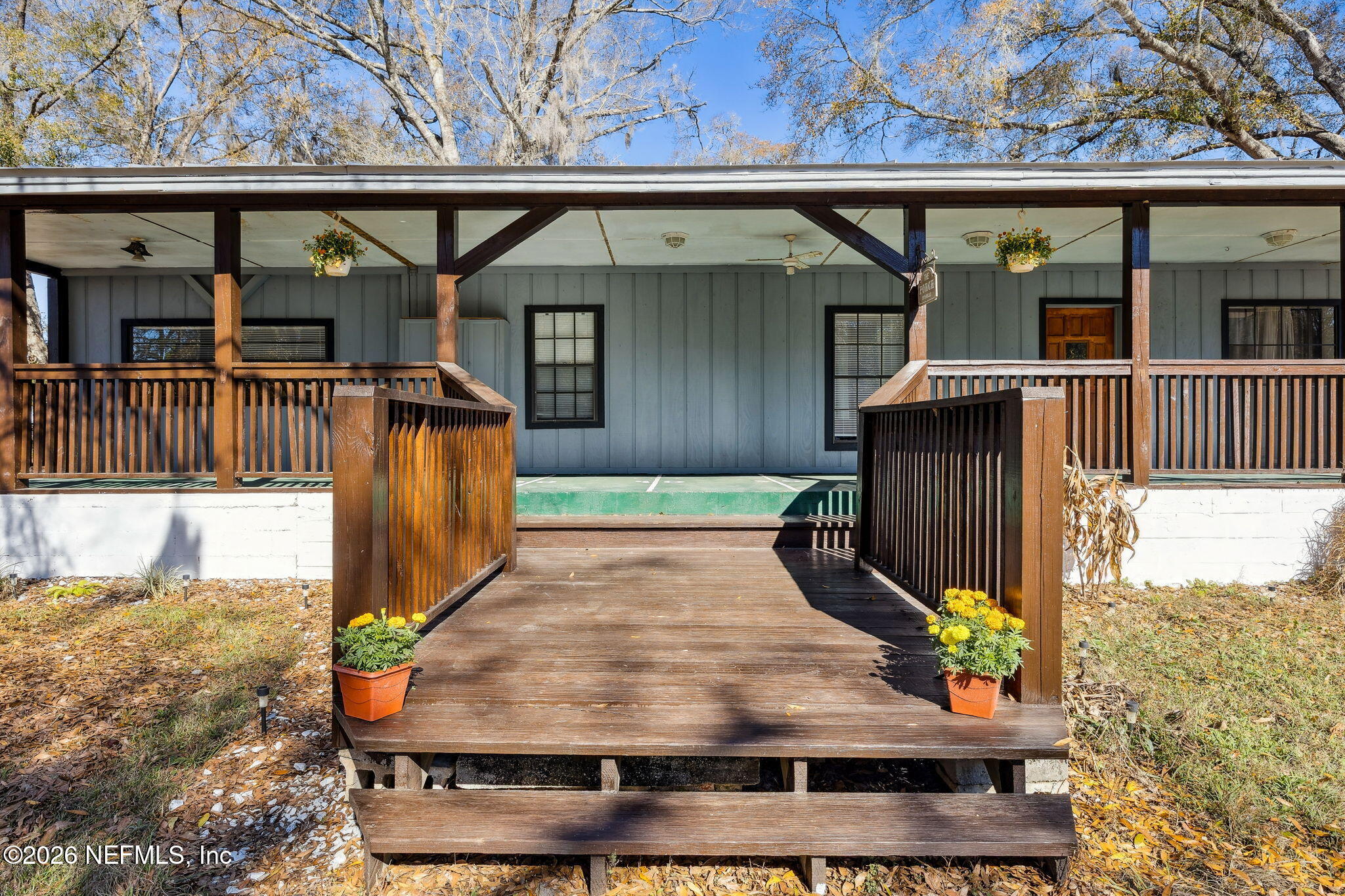 a view of a brick house with large windows