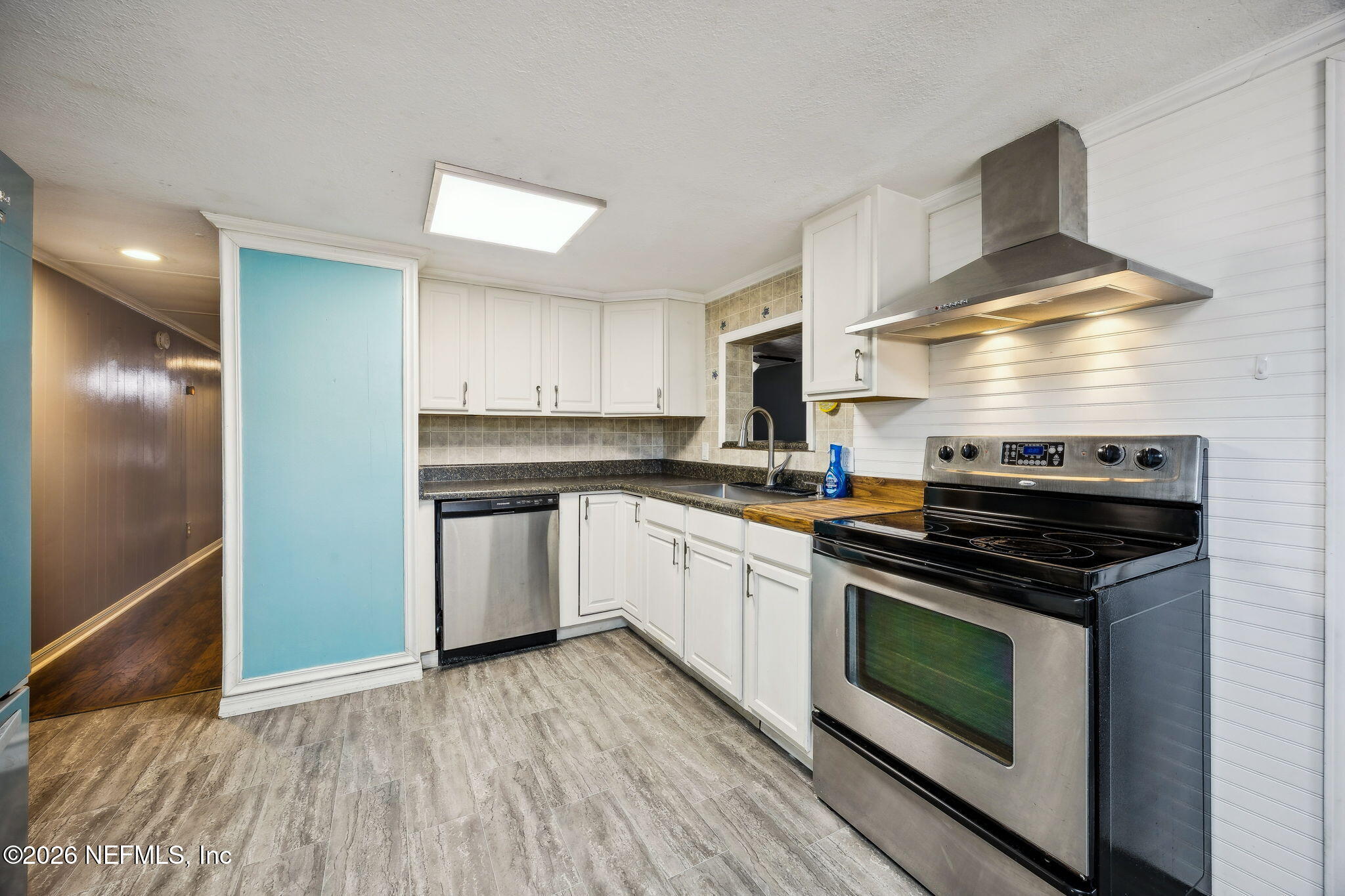 8117 Northwest County Road, Unit 225 Raiford, FL 32083 - Photo 12 of 38 a kitchen with a stove a sink and a refrigerator