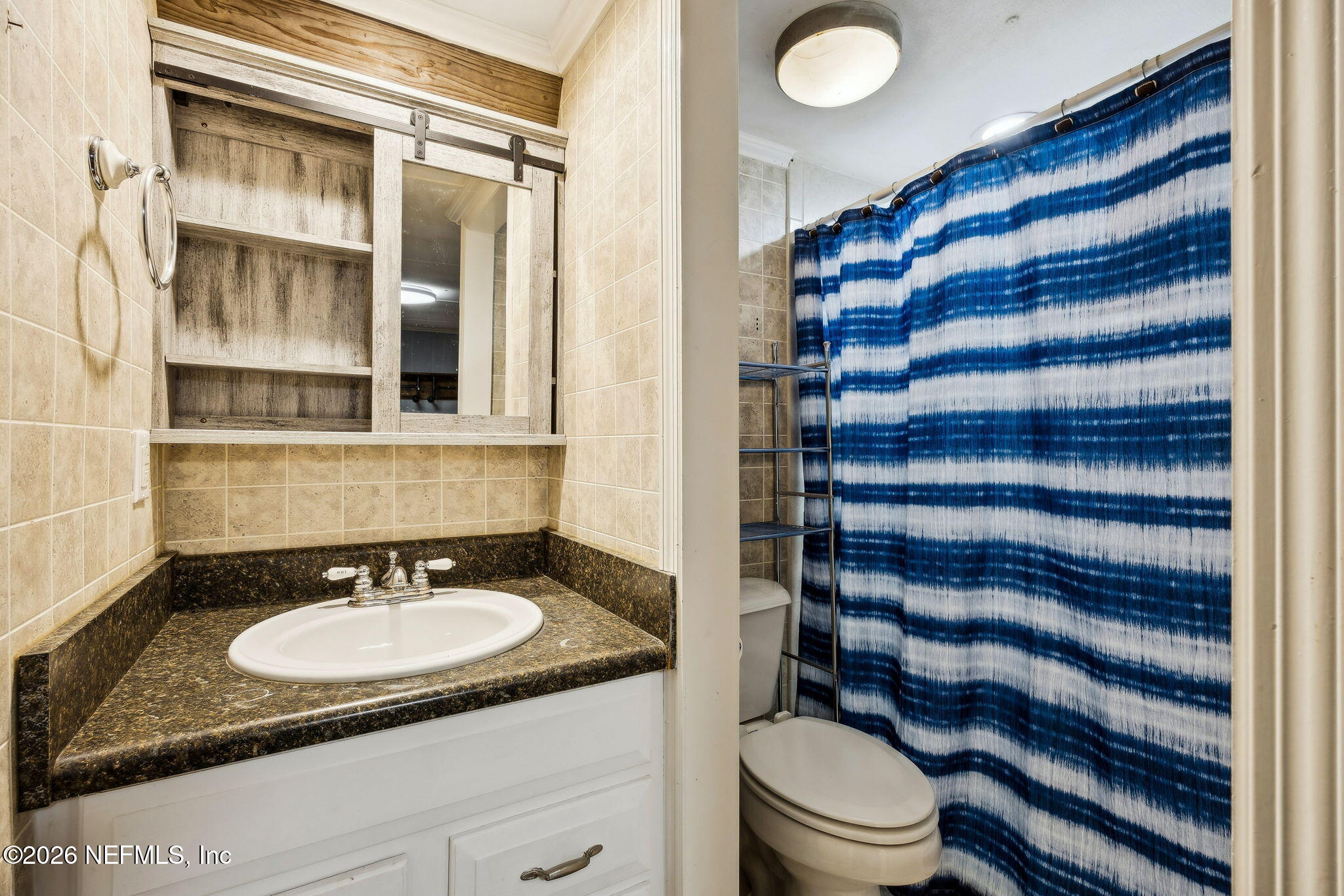 8117 Northwest County Road, Unit 225 Raiford, FL 32083 - Photo 15 of 38 a bathroom with a sink toilet and shower