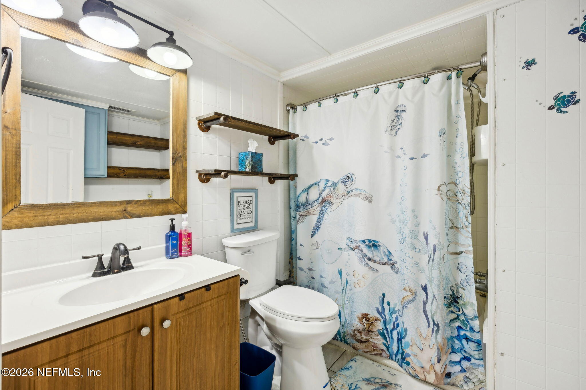 8117 Northwest County Road, Unit 225 Raiford, FL 32083 - Photo 16 of 38 a bathroom with a sink toilet and shower