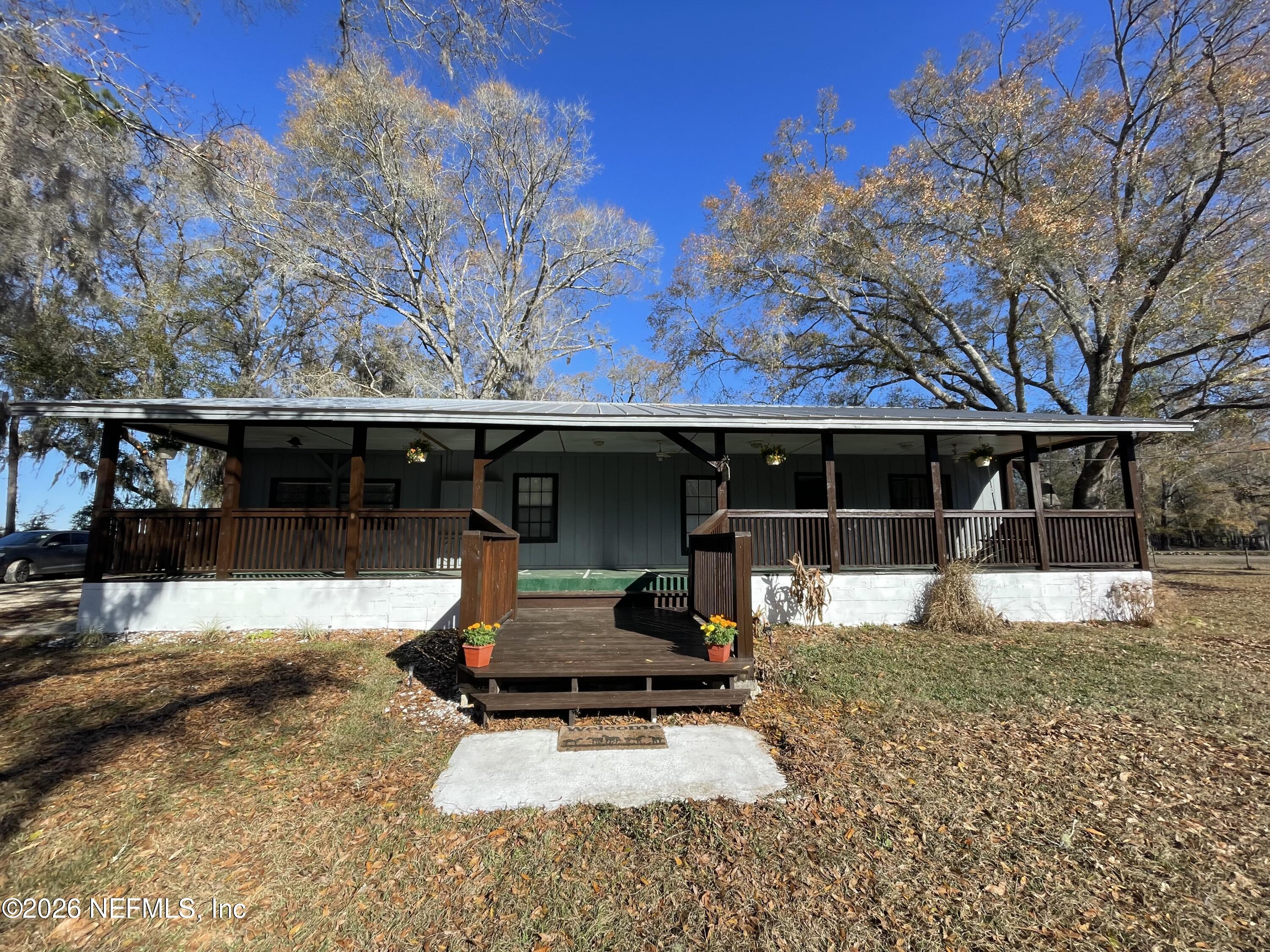 8117 Northwest County Road, Unit 225 Raiford, FL 32083 - Photo 2 of 38 a view of a house with backyard porch and sitting area