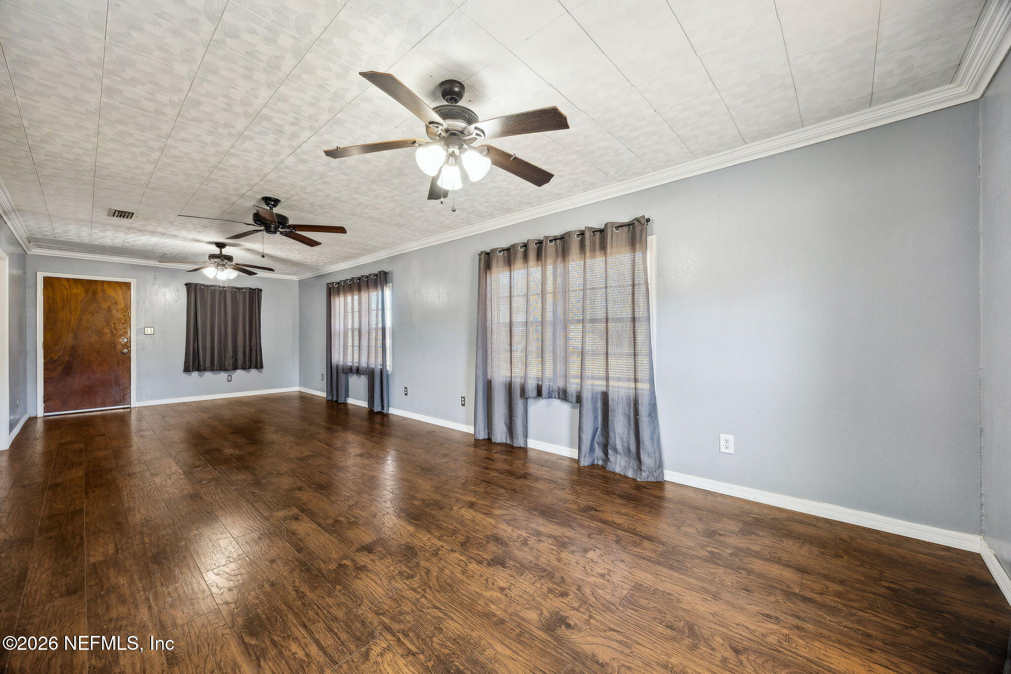 8117 Northwest County Road, Unit 225 Raiford, FL 32083 - Photo 26 of 38 a view of an empty room with wooden floor and a ceiling fan
