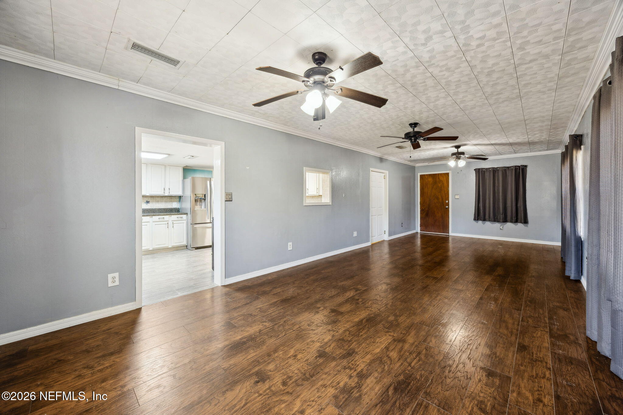 8117 Northwest County Road, Unit 225 Raiford, FL 32083 - Photo 27 of 38 a view of a livingroom with wooden floor and a ceiling fan