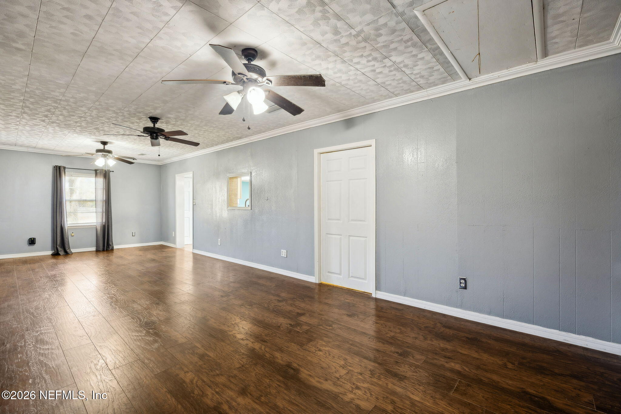 8117 Northwest County Road, Unit 225 Raiford, FL 32083 - Photo 28 of 38 a view of an empty room with wooden floor and a ceiling fan