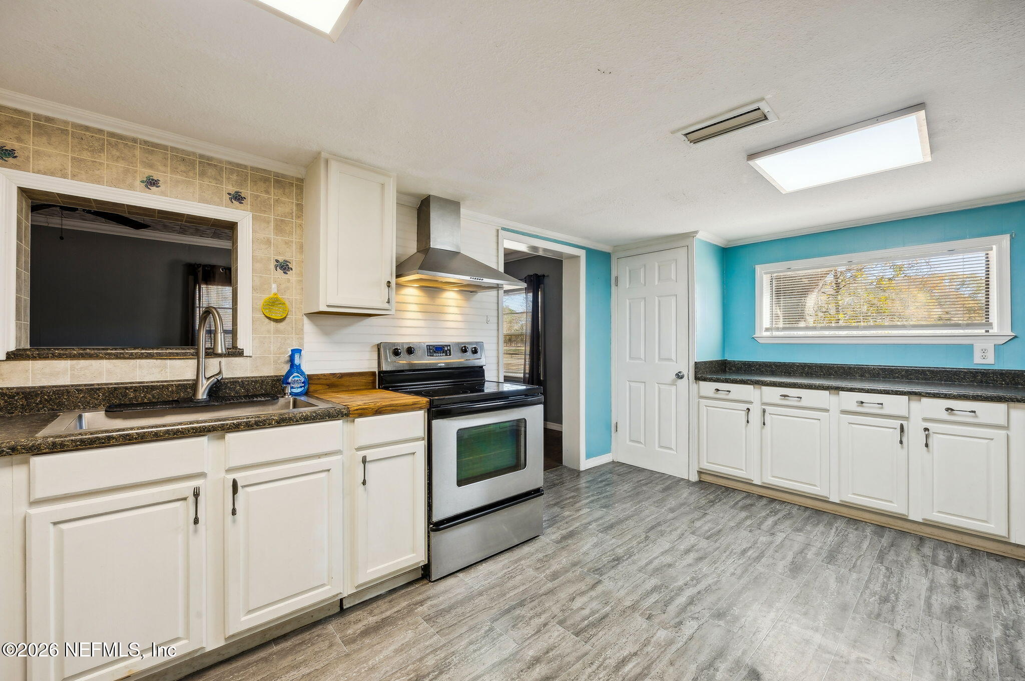 8117 Northwest County Road, Unit 225 Raiford, FL 32083 - Photo 10 of 38 a kitchen with granite countertop white cabinets and white appliances