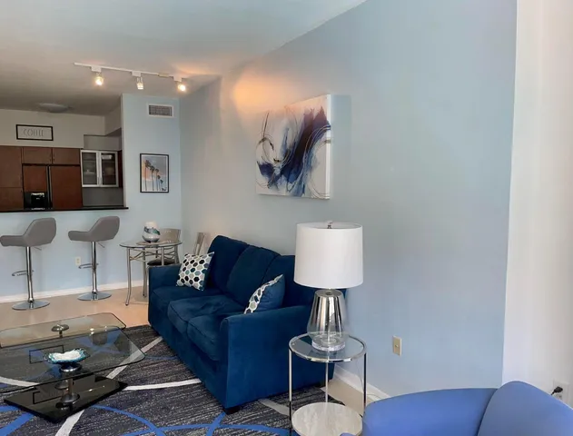 a living room with furniture and a lamp