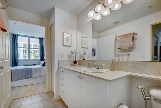 a bathroom with a sink a large mirror and a bathtub