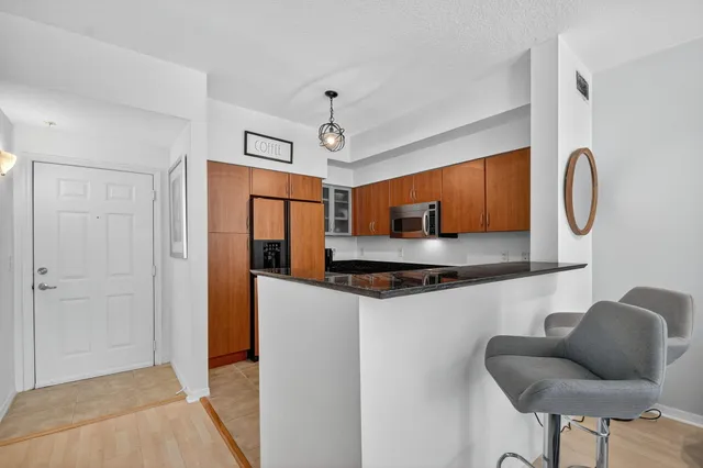 a kitchen with stainless steel appliances granite countertop a stove and a refrigerator