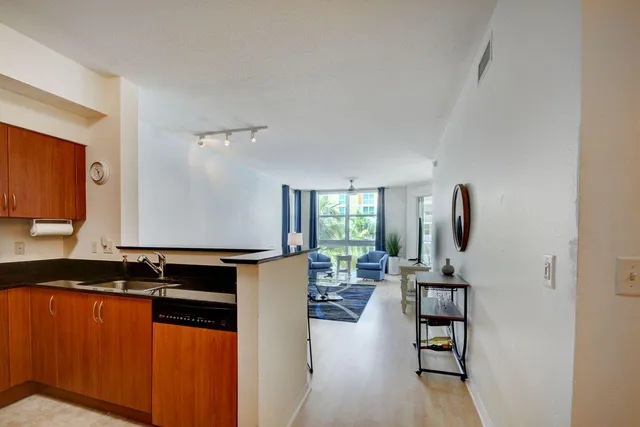 a kitchen with stainless steel appliances granite countertop a refrigerator and a stove top oven