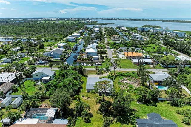 an aerial view of residential houses with outdoor space and trees