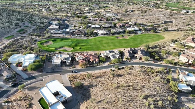 an aerial view of a house with a yard basket ball court and outdoor seating