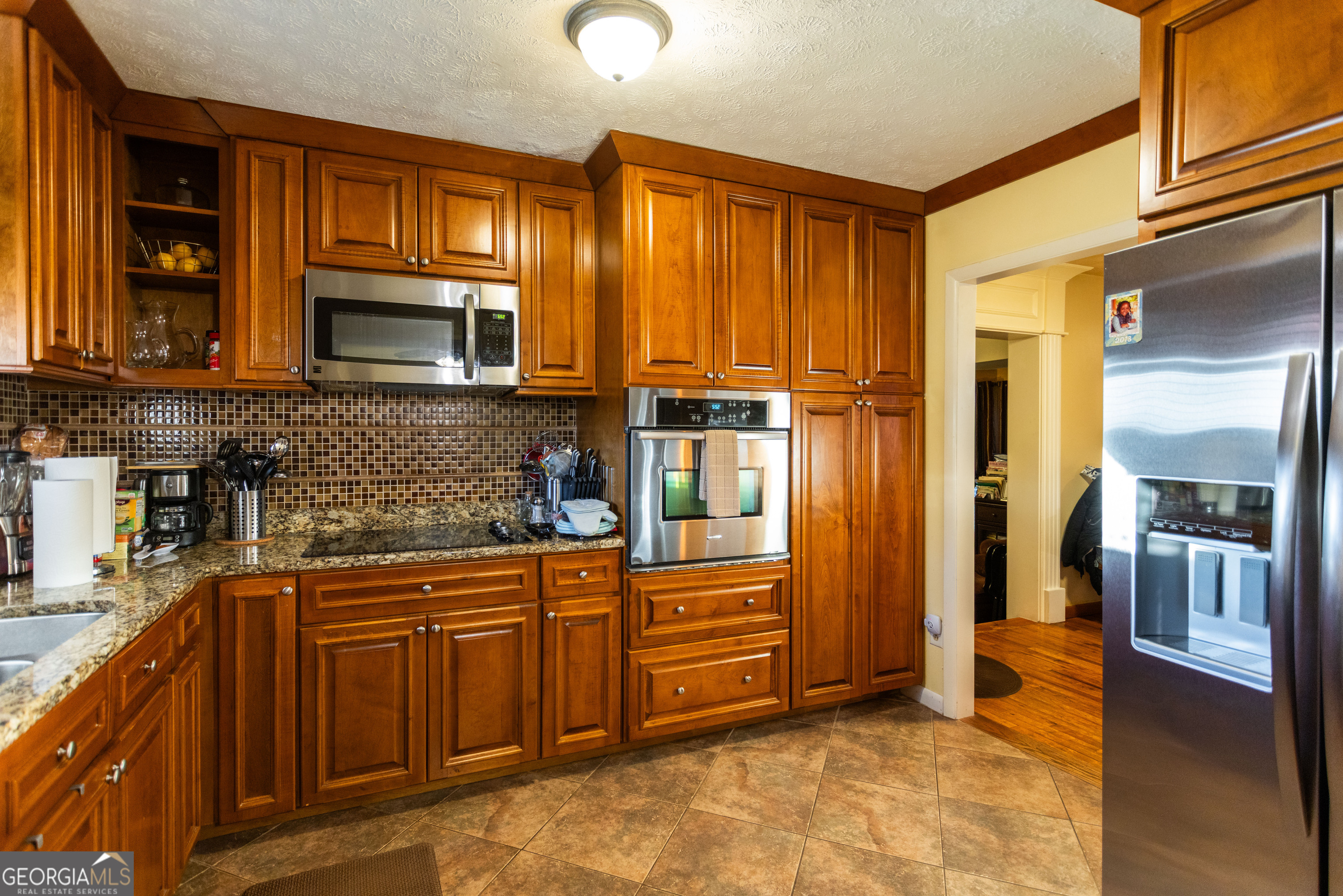 338 Boxwood Street Social Circle, GA 30025 - Photo 12 of 22 a kitchen with stainless steel appliances granite countertop a refrigerator and cabinets