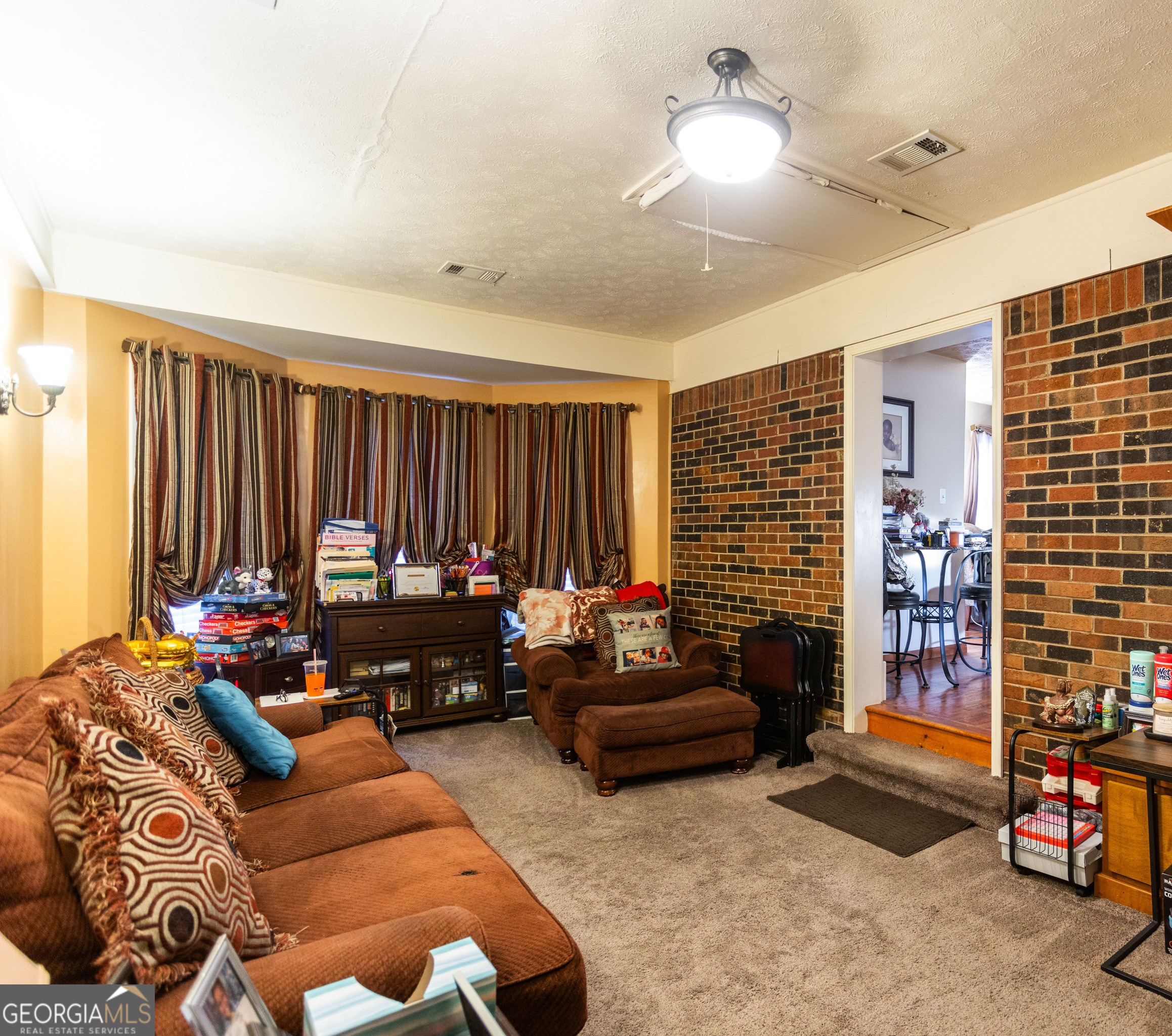 338 Boxwood Street Social Circle, GA 30025 - Photo 13 of 22 a living room with furniture and a window