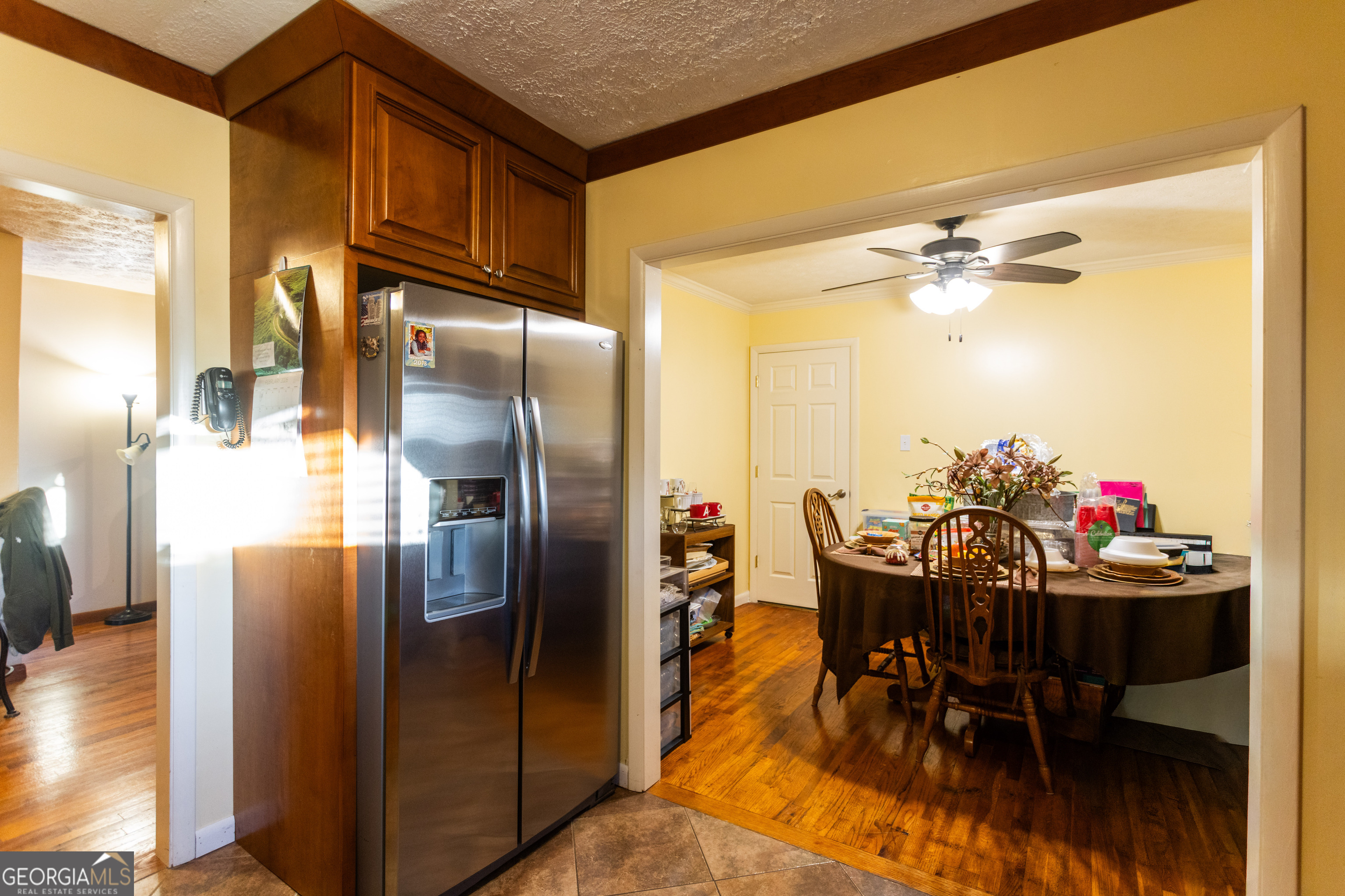 338 Boxwood Street Social Circle, GA 30025 - Photo 14 of 22 a kitchen with refrigerator and dining table