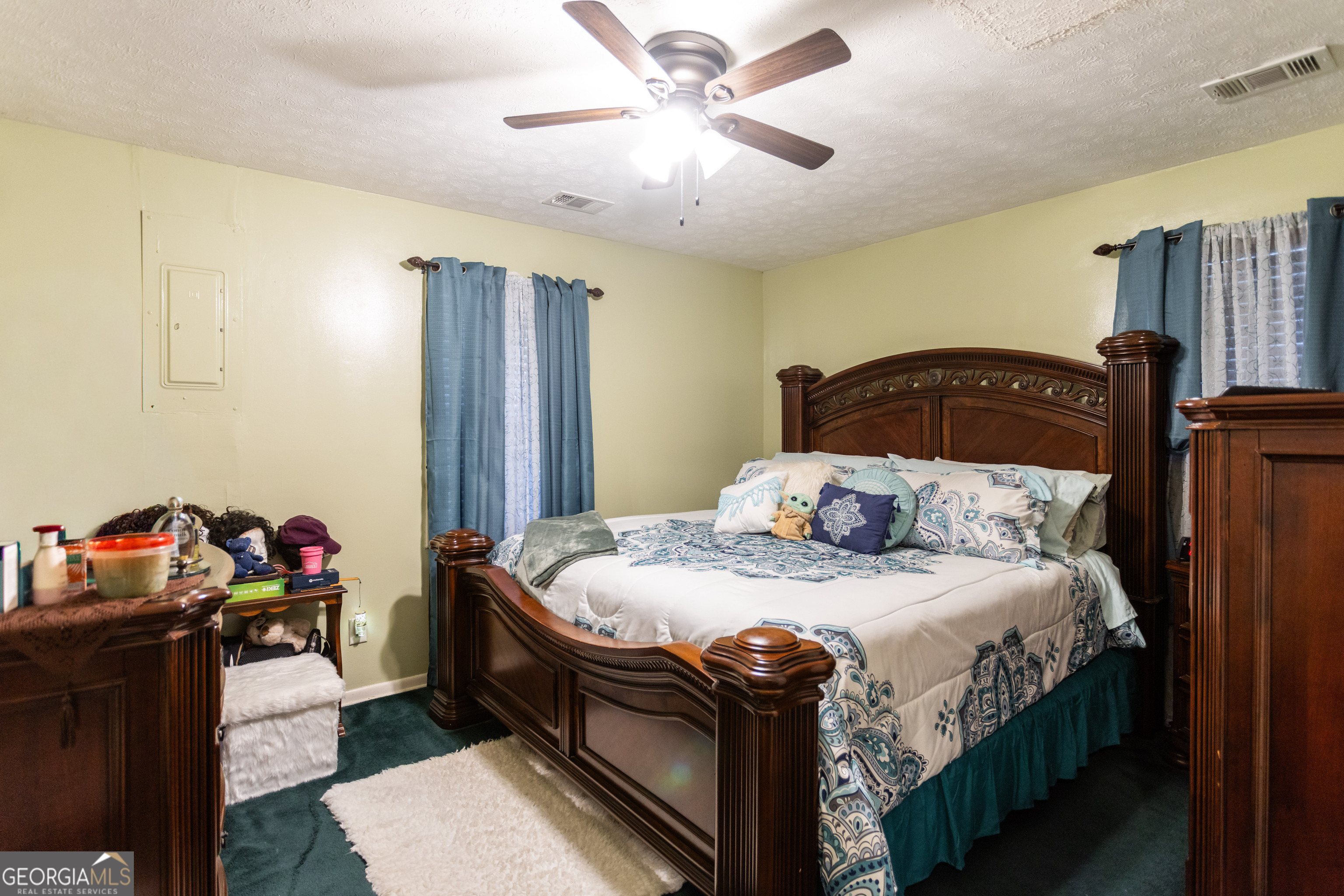 338 Boxwood Street Social Circle, GA 30025 - Photo 15 of 22 a bedroom with a bed and a chandelier