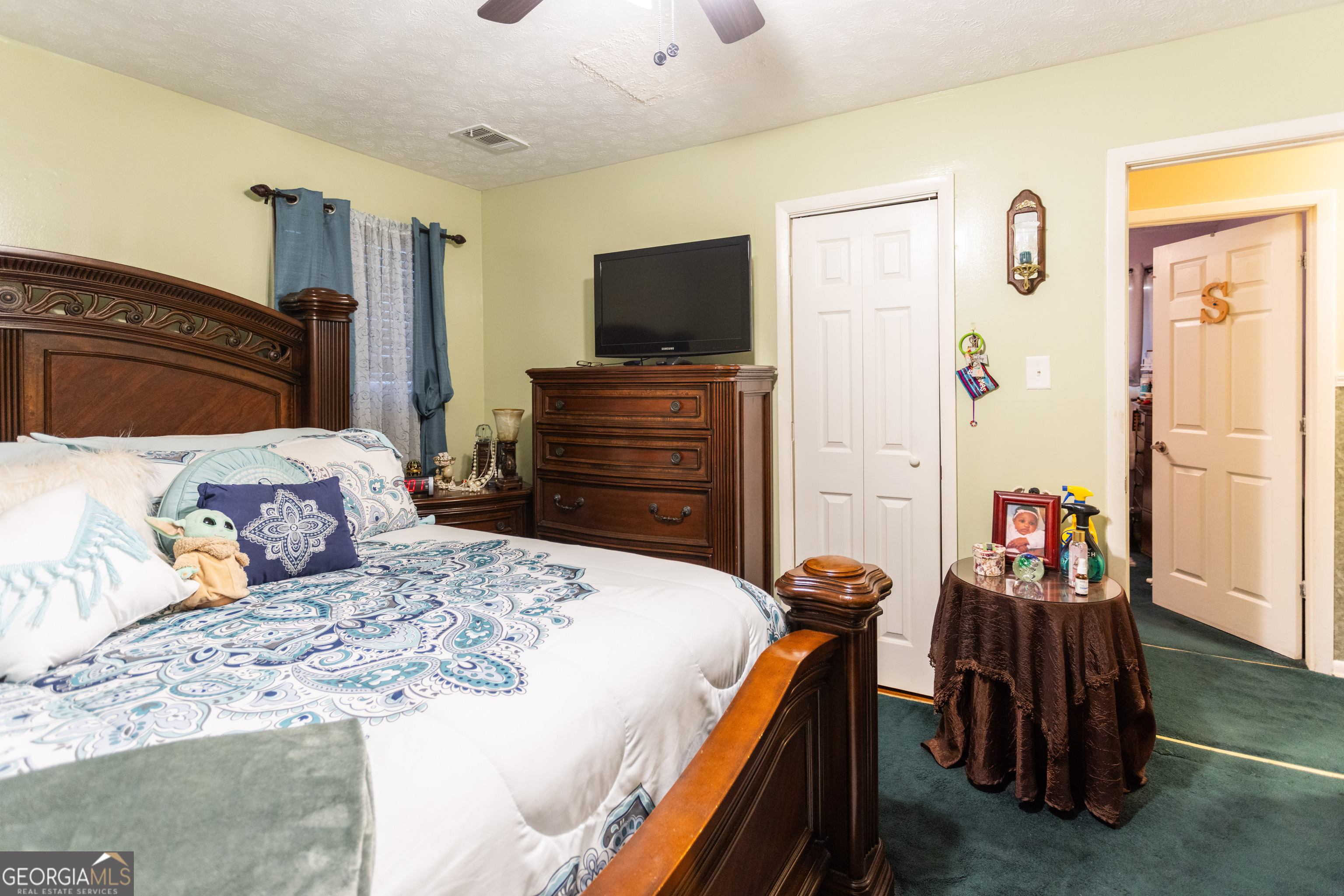 338 Boxwood Street Social Circle, GA 30025 - Photo 16 of 22 a bedroom with a bed and a flat screen tv