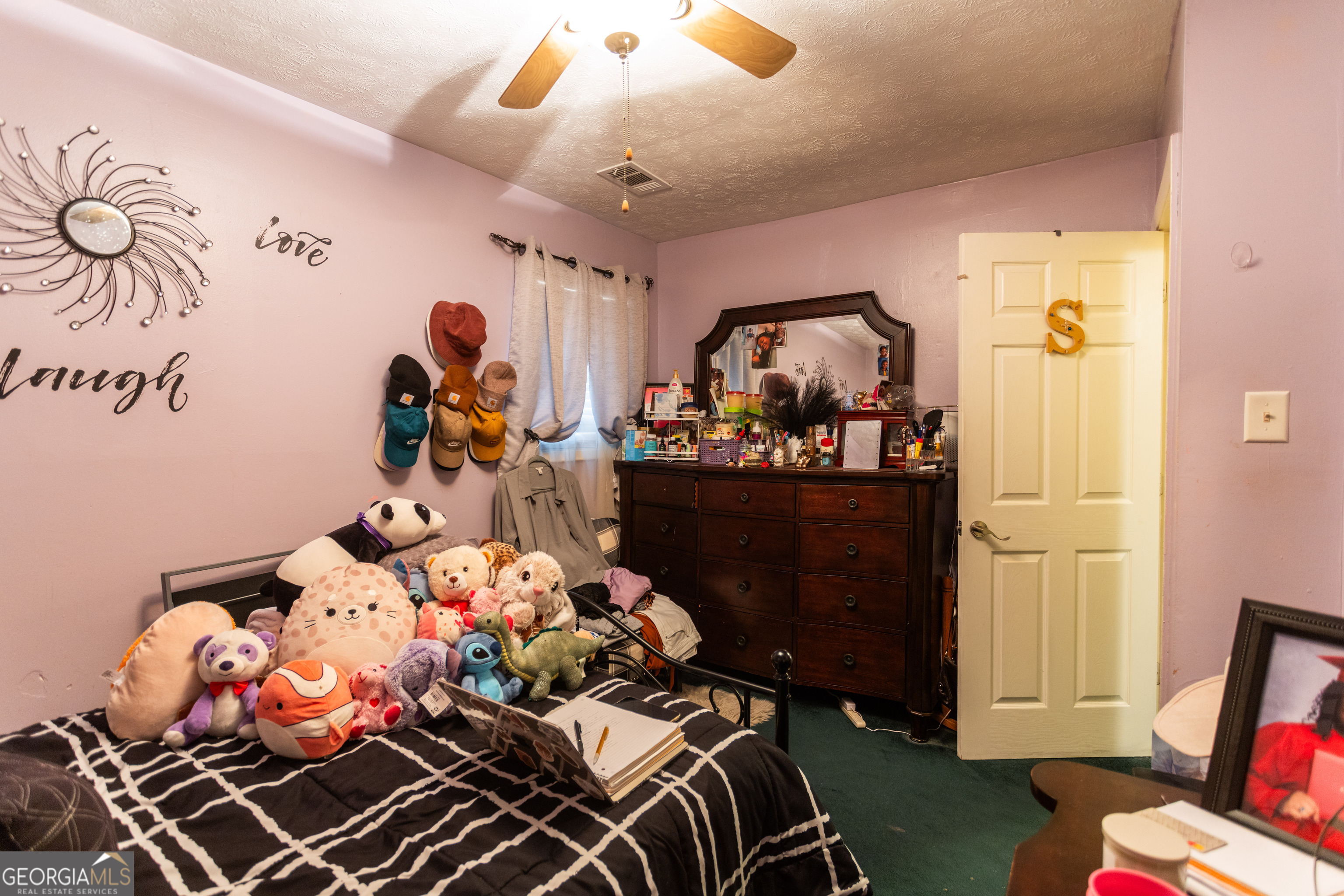338 Boxwood Street Social Circle, GA 30025 - Photo 19 of 22 a bedroom with a bed and wooden floor