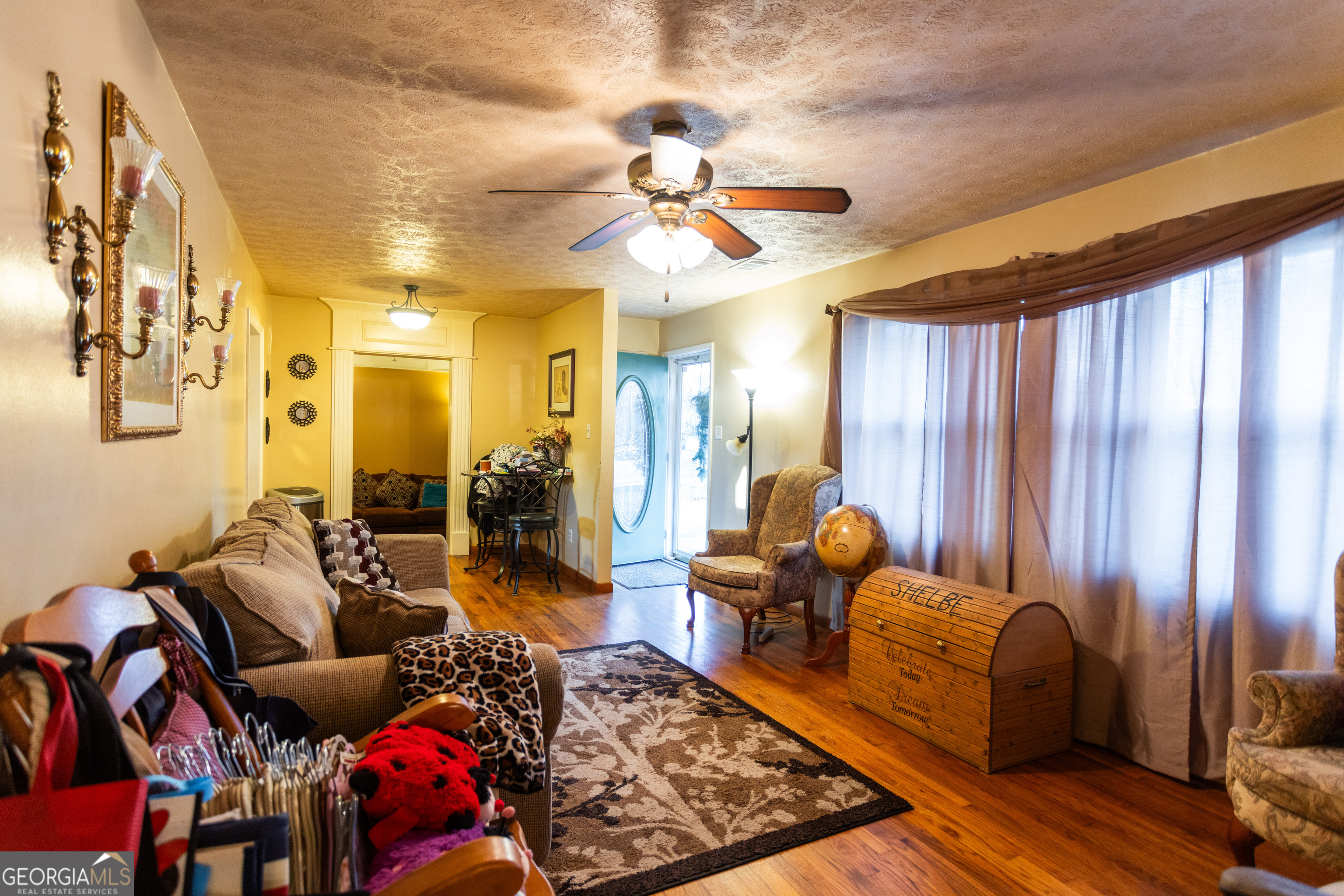 338 Boxwood Street Social Circle, GA 30025 - Photo 4 of 22 a living room with furniture and a chandelier