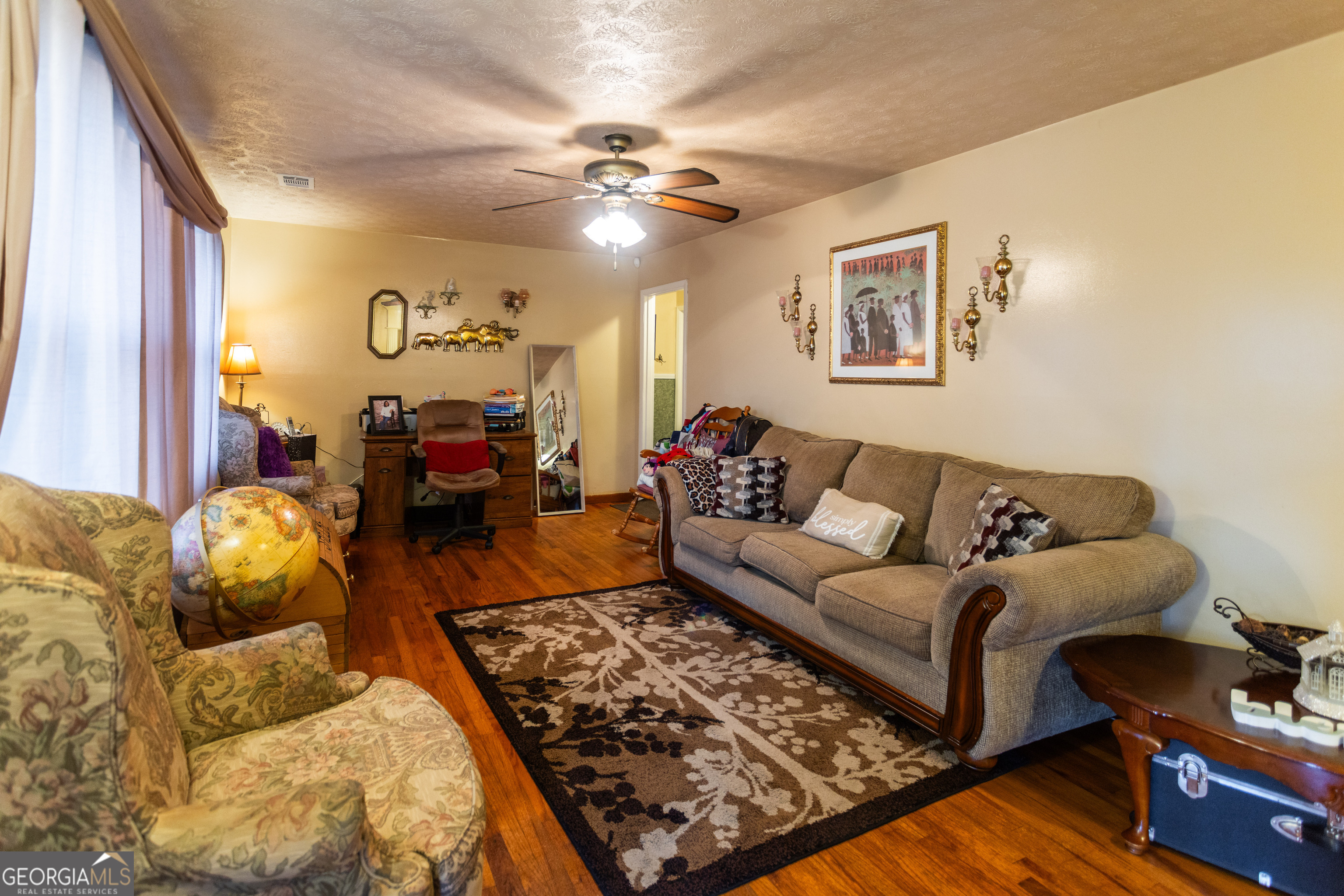 338 Boxwood Street Social Circle, GA 30025 - Photo 6 of 22 a living room with furniture and a flat screen tv