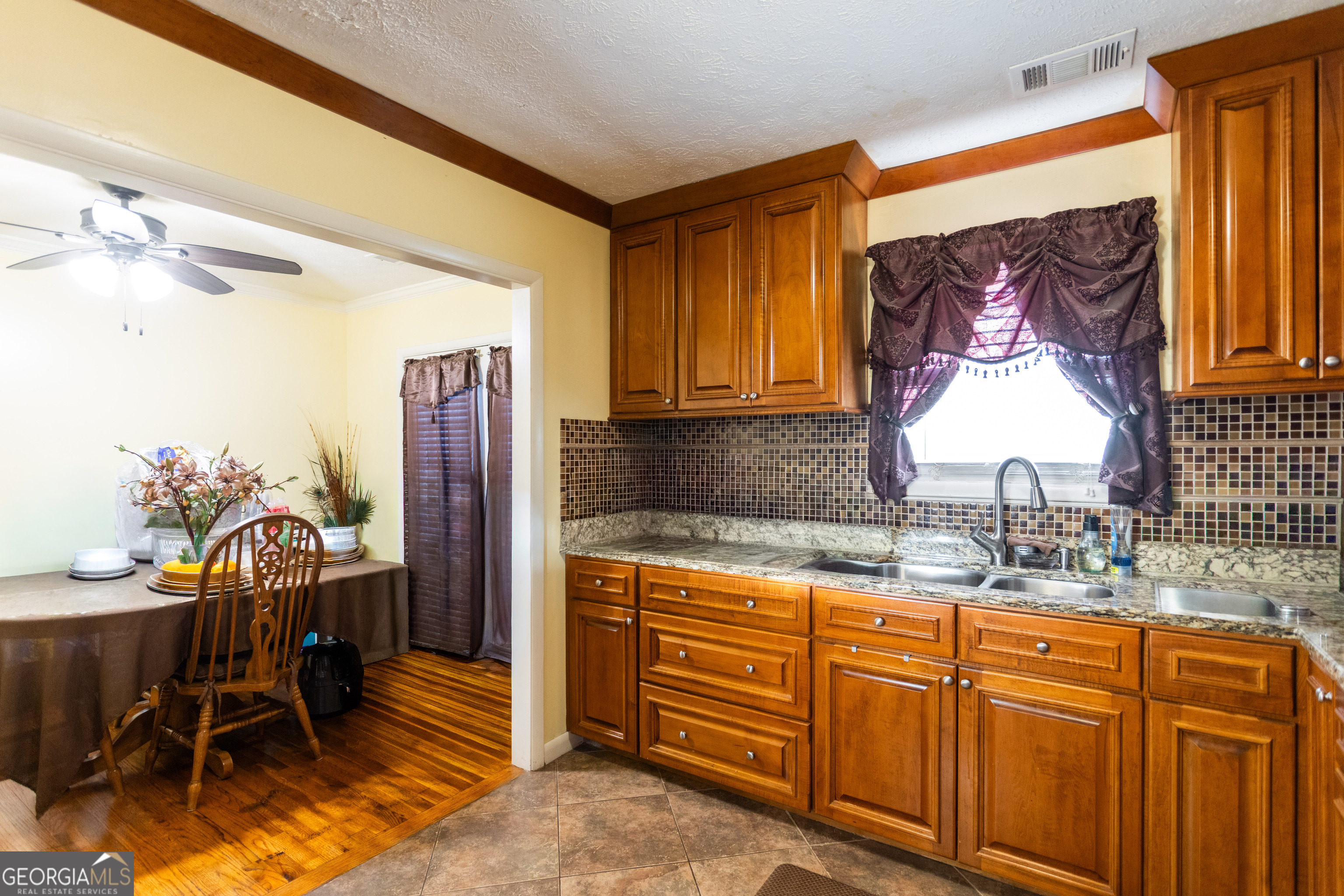 338 Boxwood Street Social Circle, GA 30025 - Photo 10 of 22 a kitchen with sink cabinets and dining table