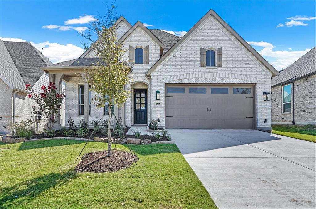 1252 Emilia Road Fate, TX 75087 - Photo 1 of 1 a front view of a house with a yard and garage