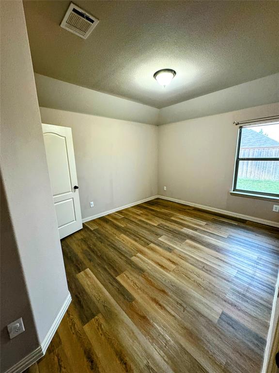 236 Archer Way Forney, TX 75126 - Photo 25 of 35 an empty room with wooden floor and windows