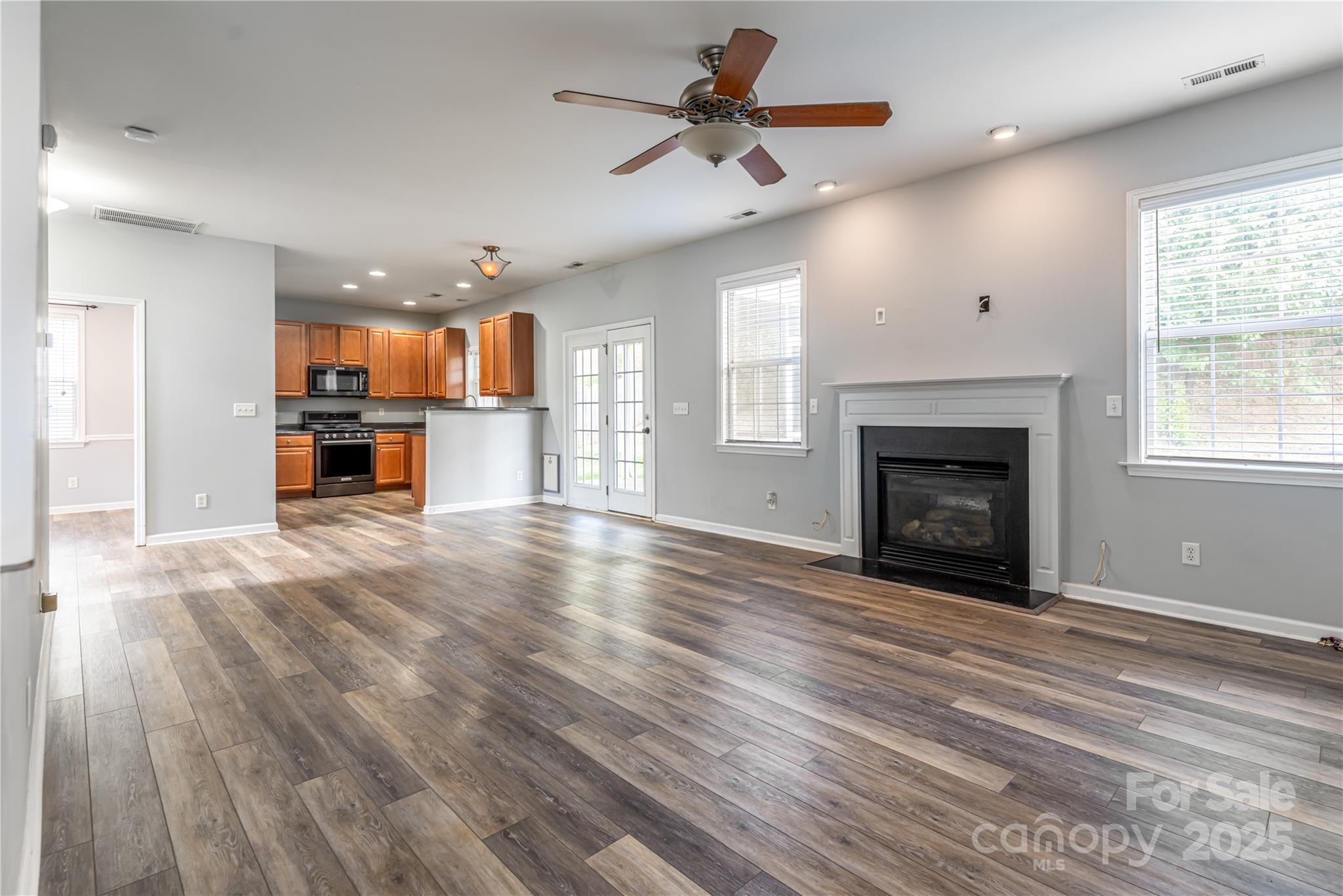 163 Yadkin Road Fletcher, NC 28732 - Photo 11 of 43 an empty room with kitchen view and a fireplace