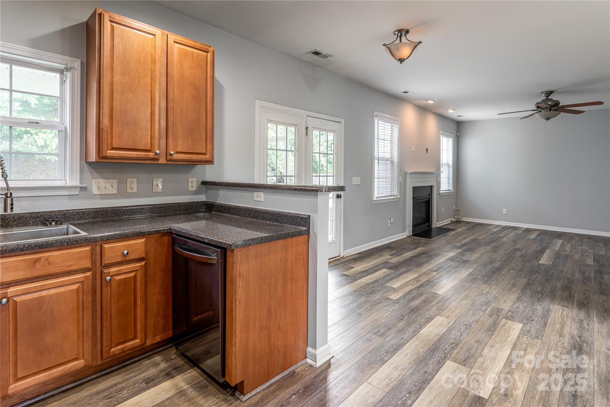 163 Yadkin Road Fletcher, NC 28732 - Photo 19 of 43 a kitchen with granite countertop a sink cabinets and wooden floor