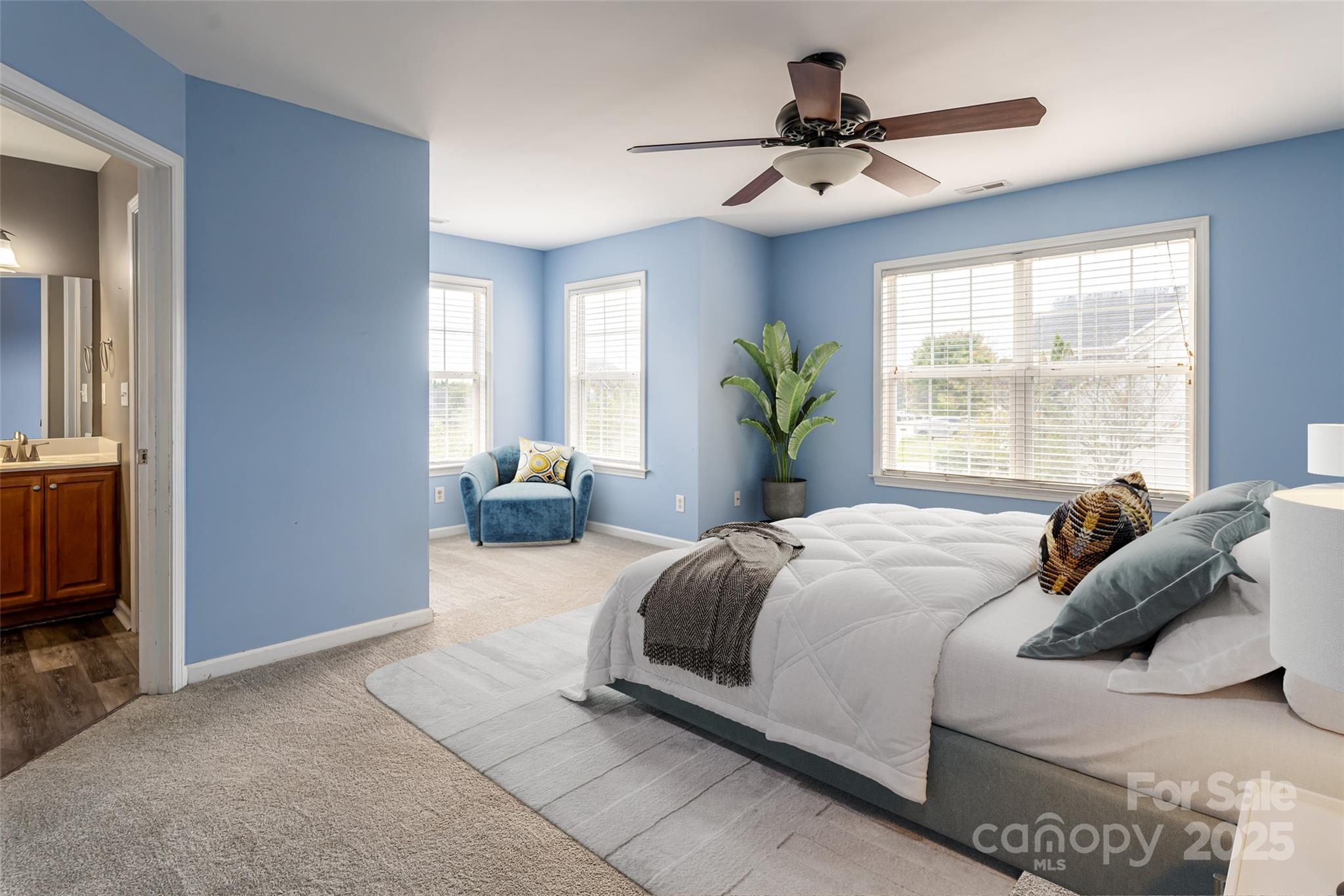 163 Yadkin Road Fletcher, NC 28732 - Photo 26 of 43 a bedroom with a large bed and a chandelier