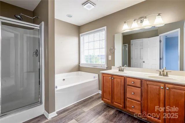 a bathroom with a tub shower and sink