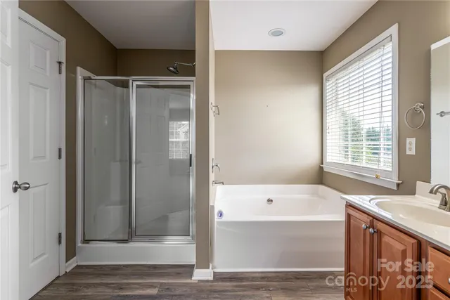 a spacious bathroom with a double vanity sink and a mirror