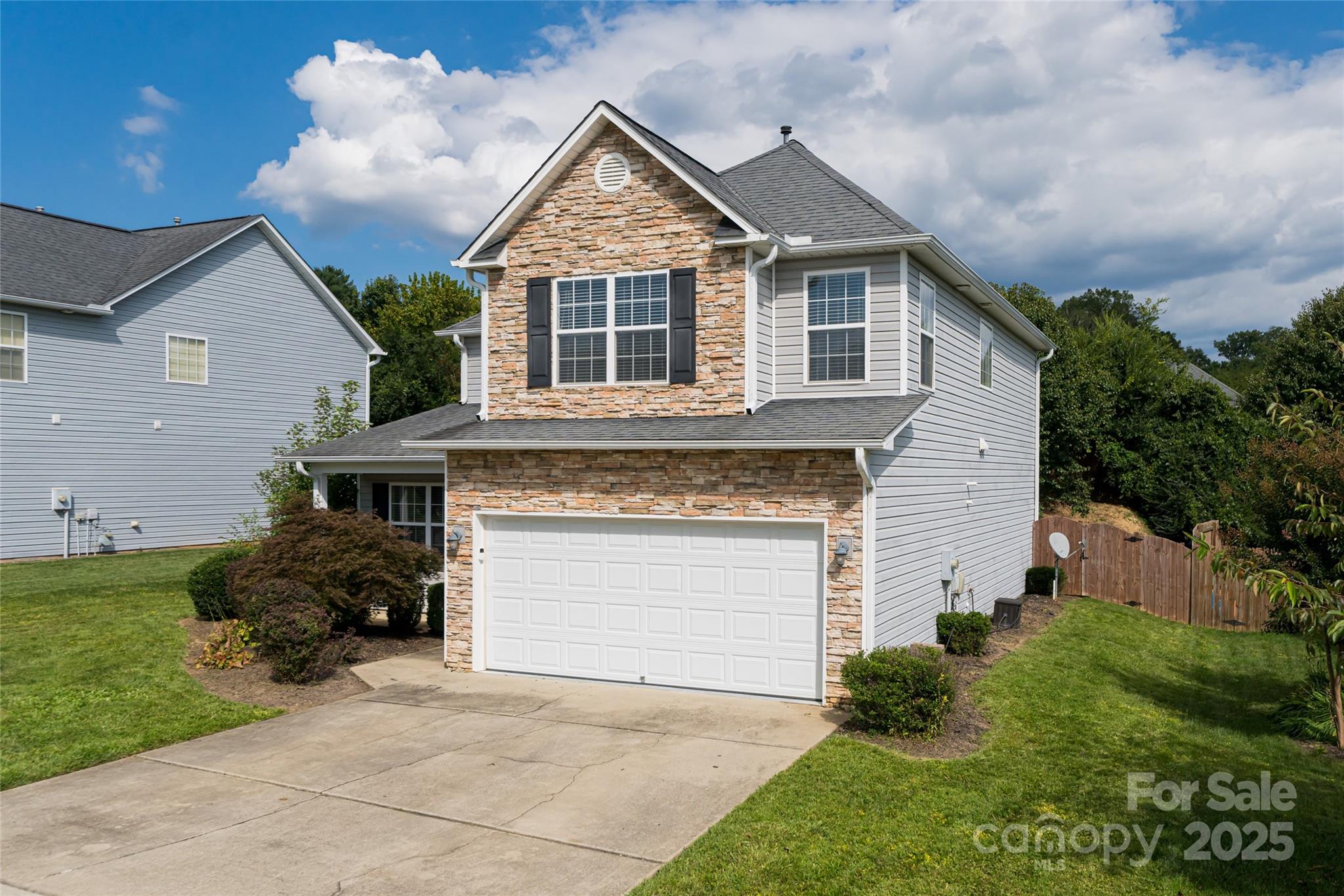 163 Yadkin Road Fletcher, NC 28732 - Photo 3 of 43 a front view of a house with a garden and plants