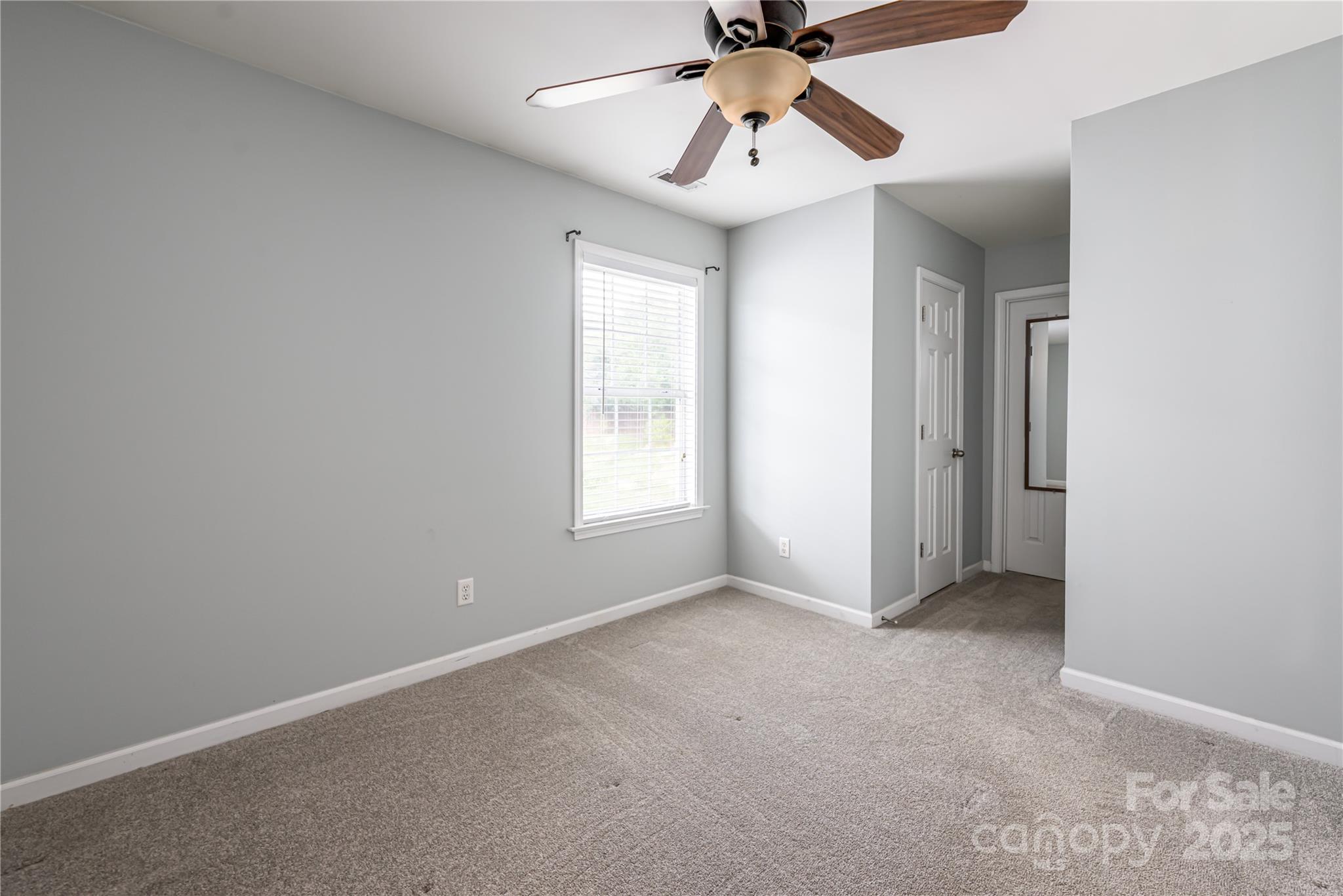 163 Yadkin Road Fletcher, NC 28732 - Photo 36 of 43 an empty room with chandelier fan and windows