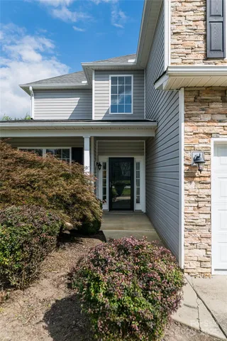 a front view of a house with garden