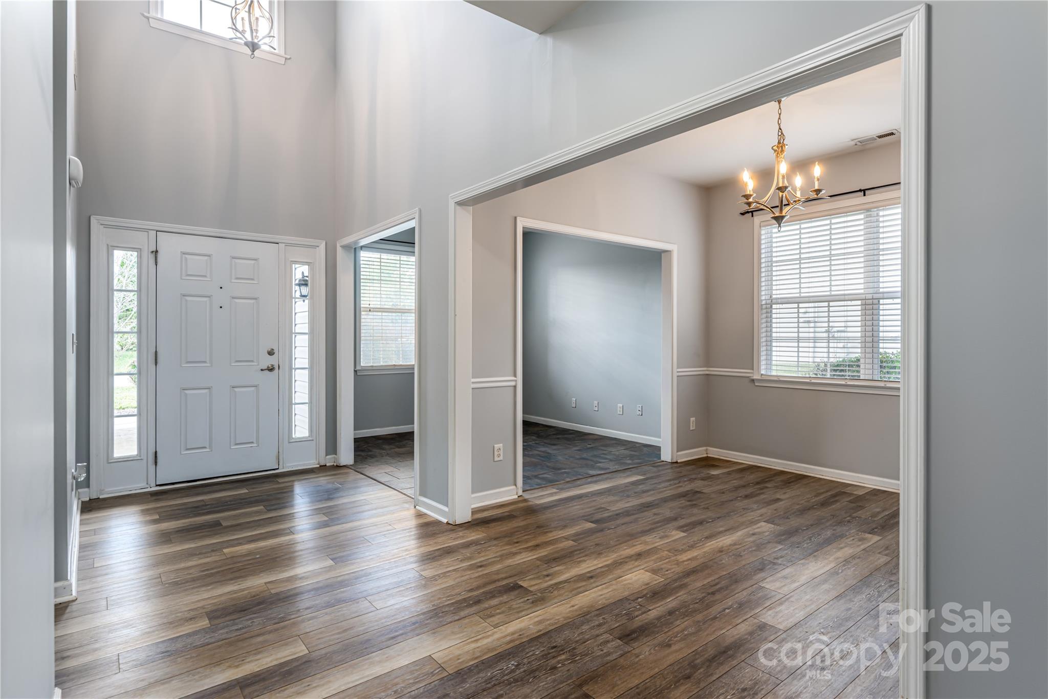 163 Yadkin Road Fletcher, NC 28732 - Photo 6 of 43 an empty room with wooden floor chandelier and windows