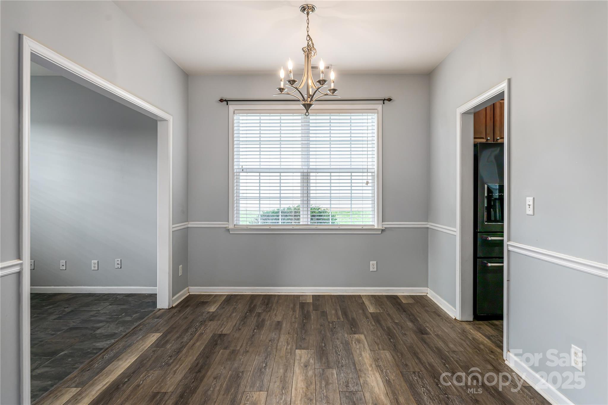 163 Yadkin Road Fletcher, NC 28732 - Photo 8 of 43 an empty room with wooden floor and windows