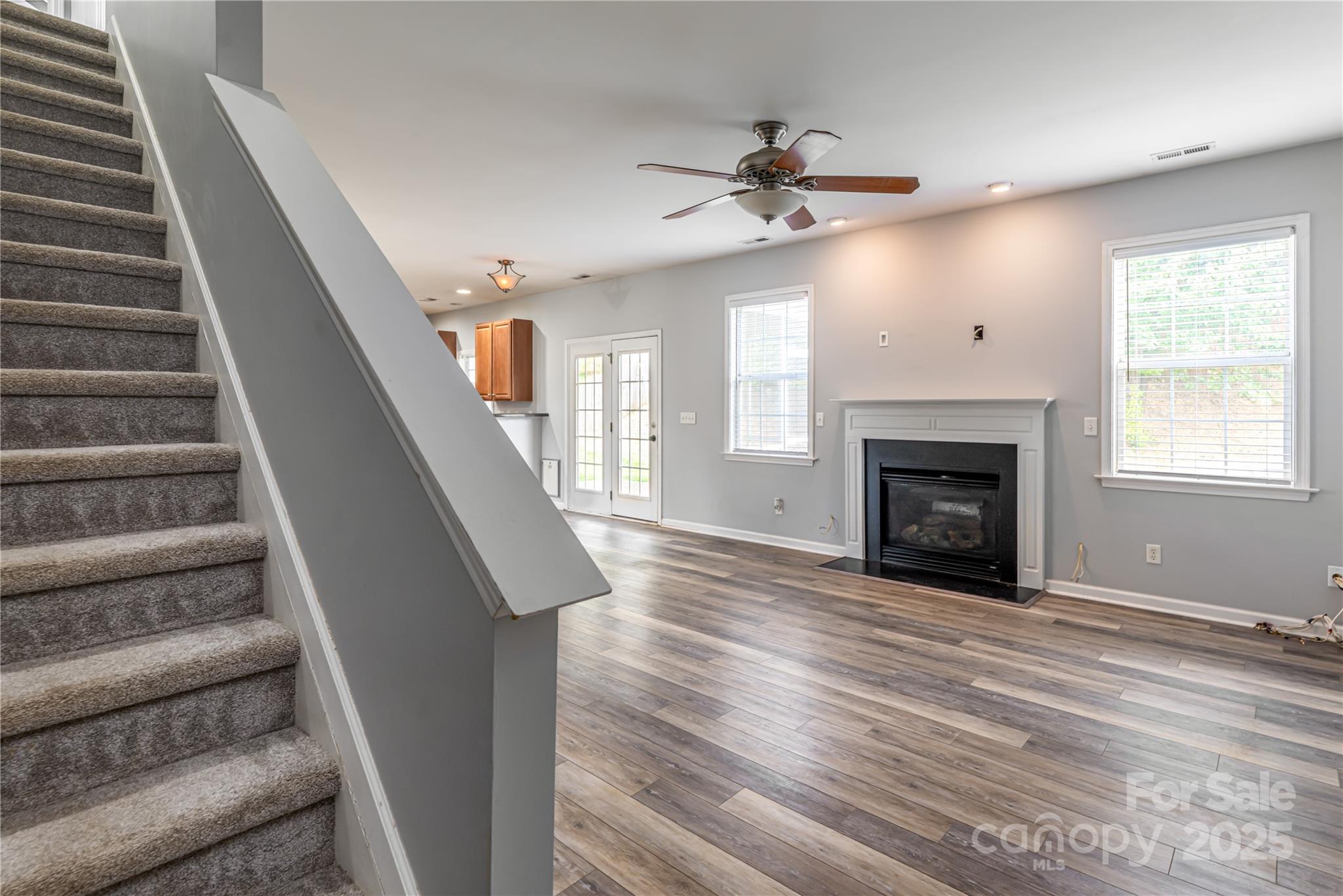 163 Yadkin Road Fletcher, NC 28732 - Photo 10 of 43 a view of an empty room with wooden floor fireplace and a window