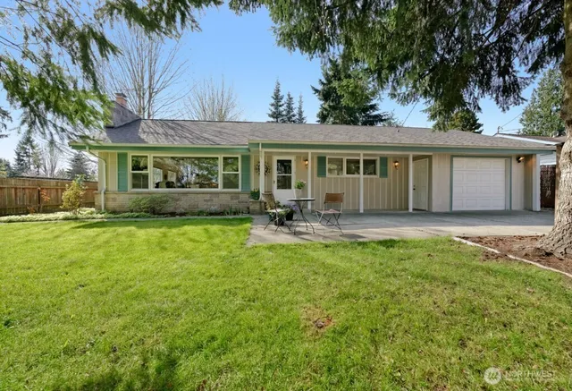 a house view with swimming pool and garden space