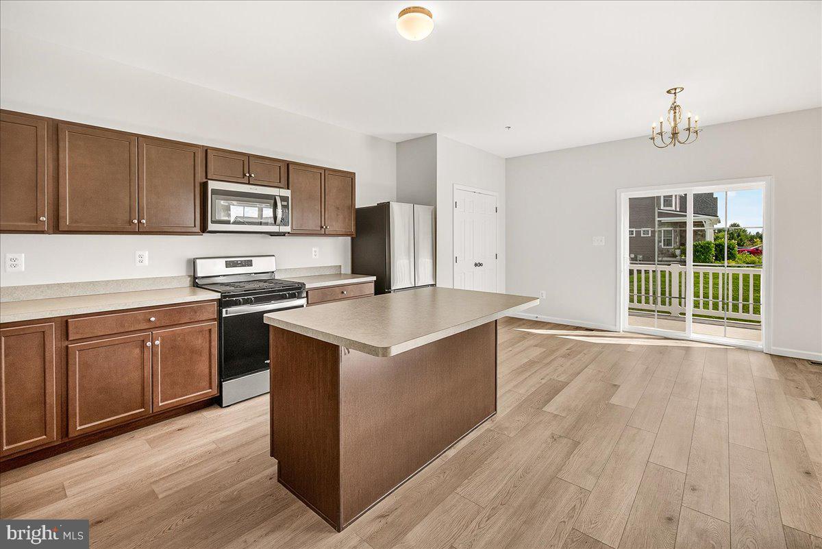1600 Corn Crib Place Frederick, MD 21702 - Photo 14 of 38 a kitchen with stainless steel appliances granite countertop a stove a sink and a microwave