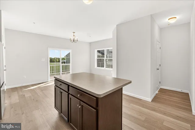a kitchen that has a sink and a wooden floor