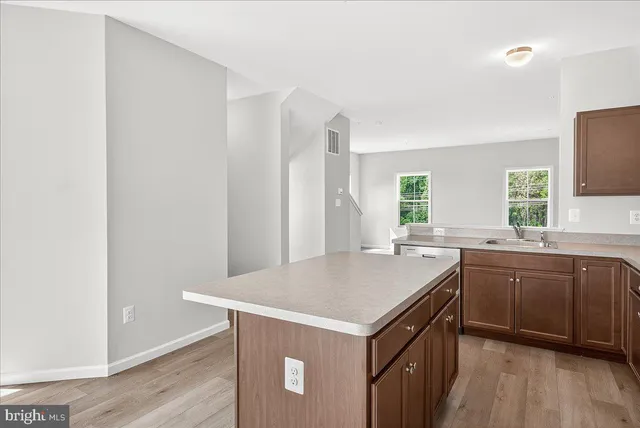 a kitchen with a stove a sink and a refrigerator