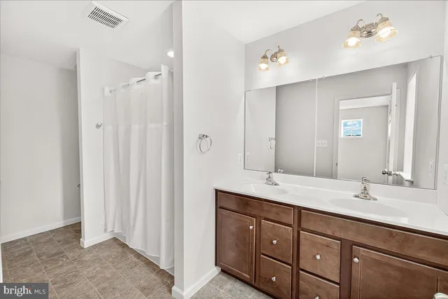 a bathroom with a double vanity sink and mirror