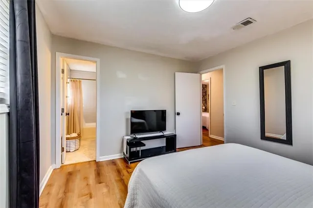 a bedroom with a bed and a flat screen tv