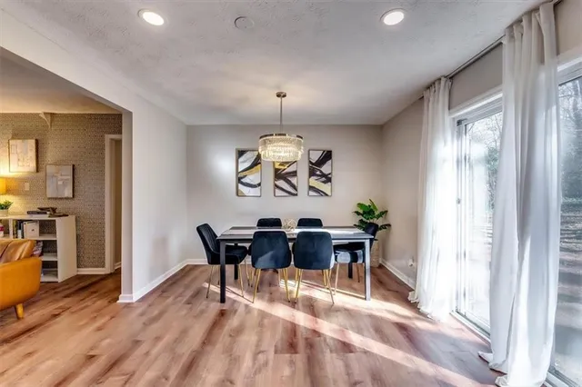 a view of a dining room with furniture window and wooden floor
