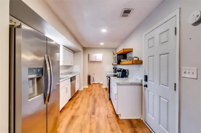 a hallway with a washer and dryer